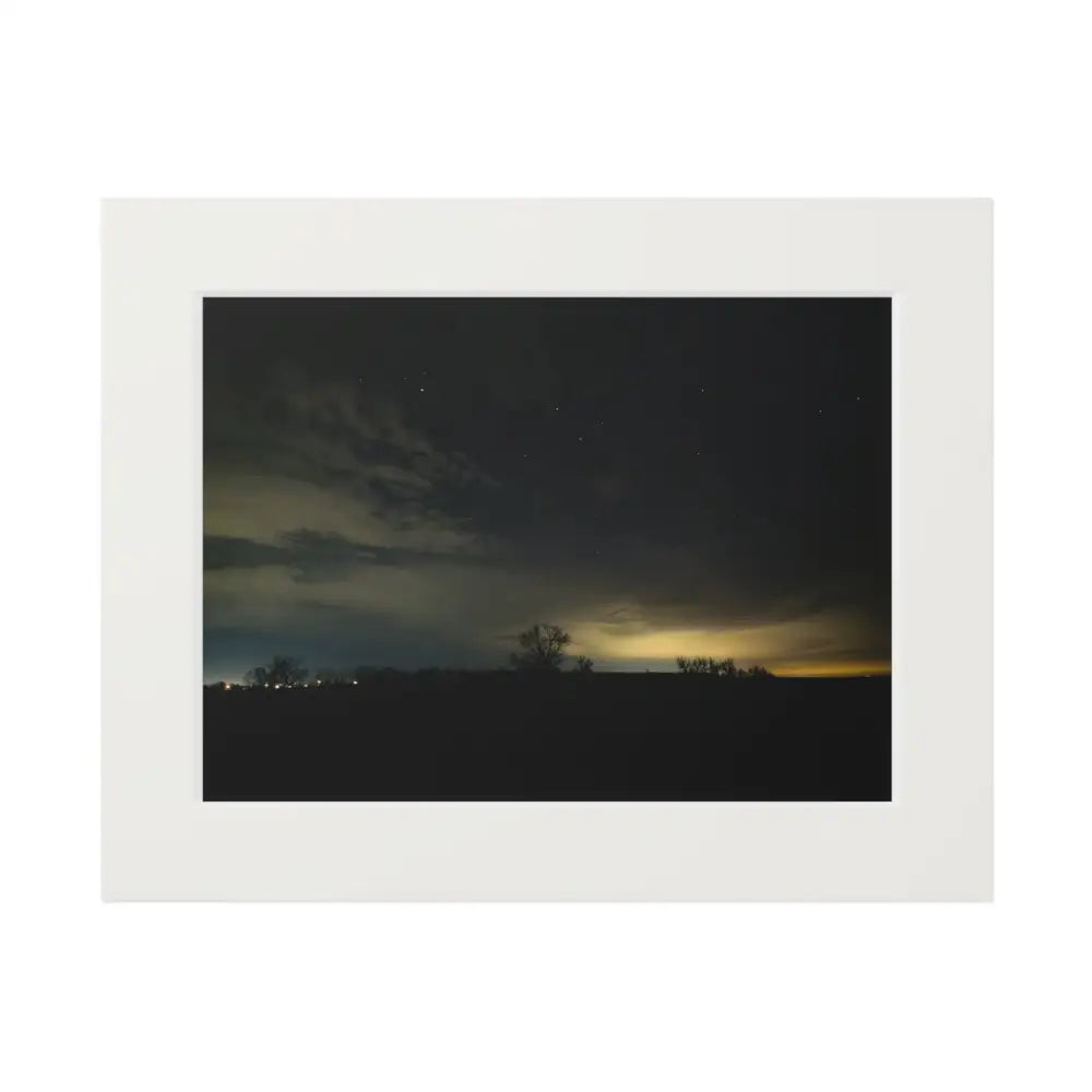 Framed photograph of a night sky with stars and clouds, featuring a white border.